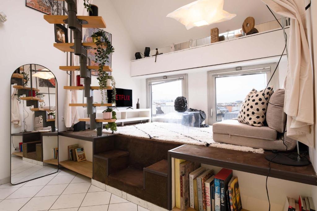 a living room with a book shelf and a couch at Loft Duplex Terrasse View on Paris in Paris