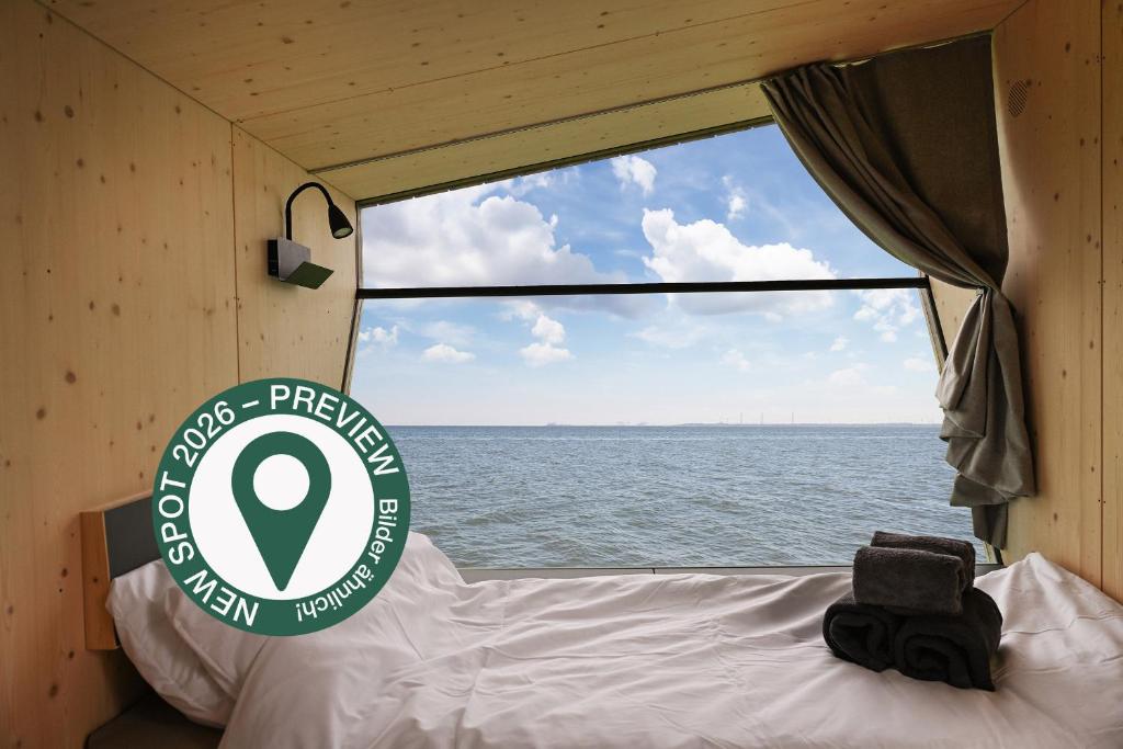 a view of the ocean from the back of a boat at Sleep Space 23 - Green Tiny Spot Schillig in Wangerland