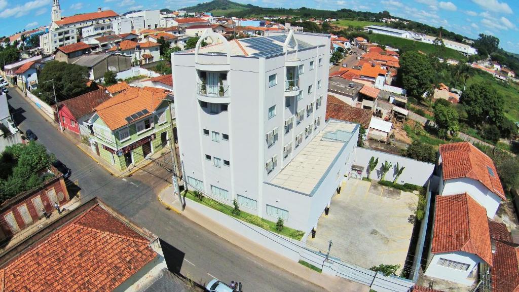 an overhead view of a white building in a city at Matinada Palace Hotel in Paraguaçu