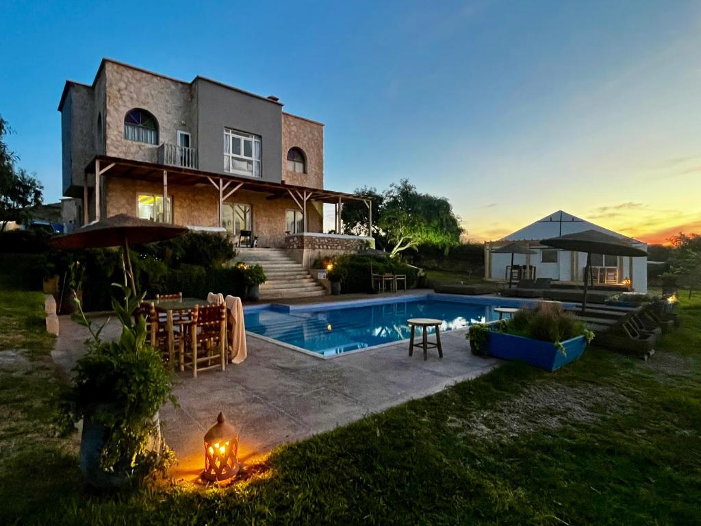 a house with a swimming pool in the yard at Riad La Tempérance Kite & Wellness in Essaouira