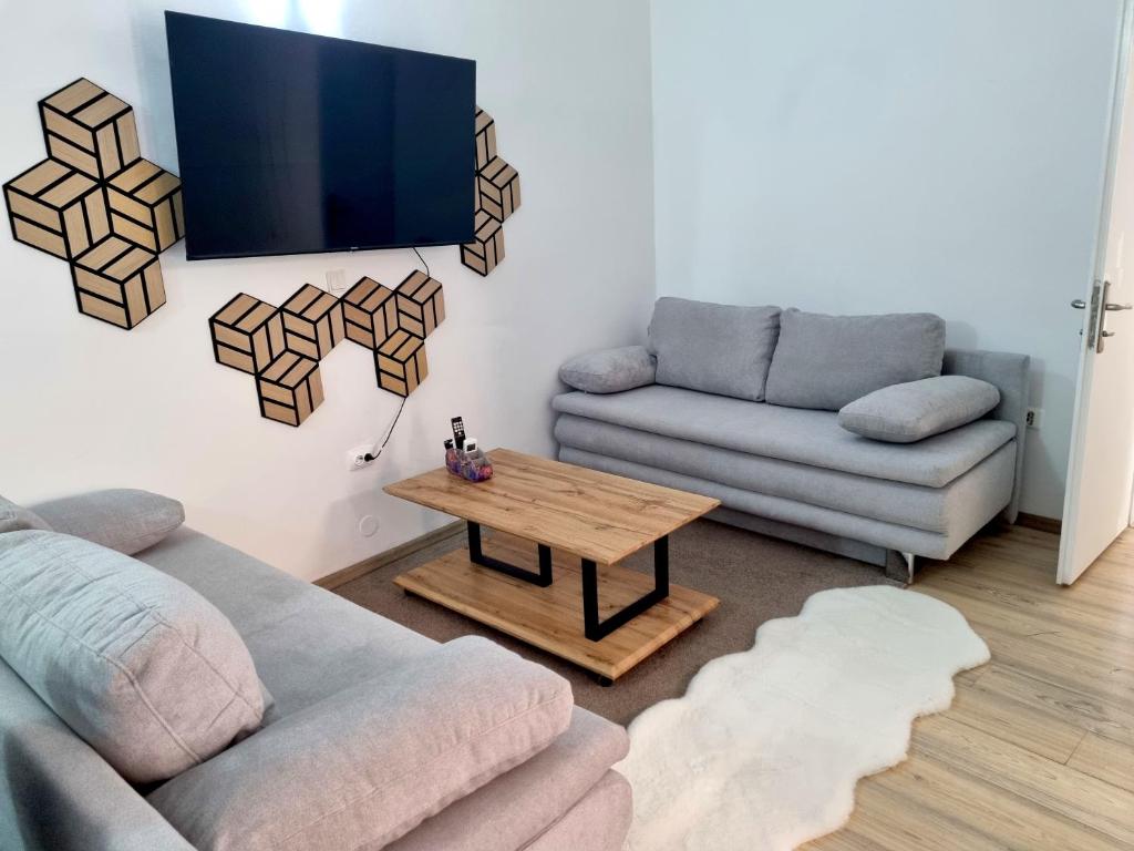 a living room with two couches and a coffee table at Lion Apartments in Vodice