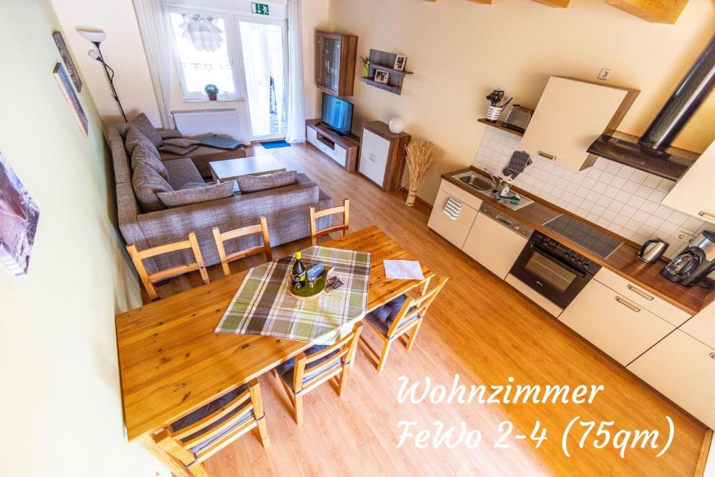 a living room with a table and chairs and a couch at Ferienwohnungen Margaretenhof am Plauer See in Brandenburg an der Havel