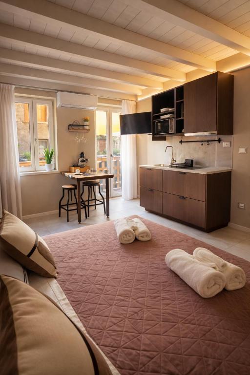 a kitchen with two towels sitting on the floor at ES Apartments in Nago-Torbole
