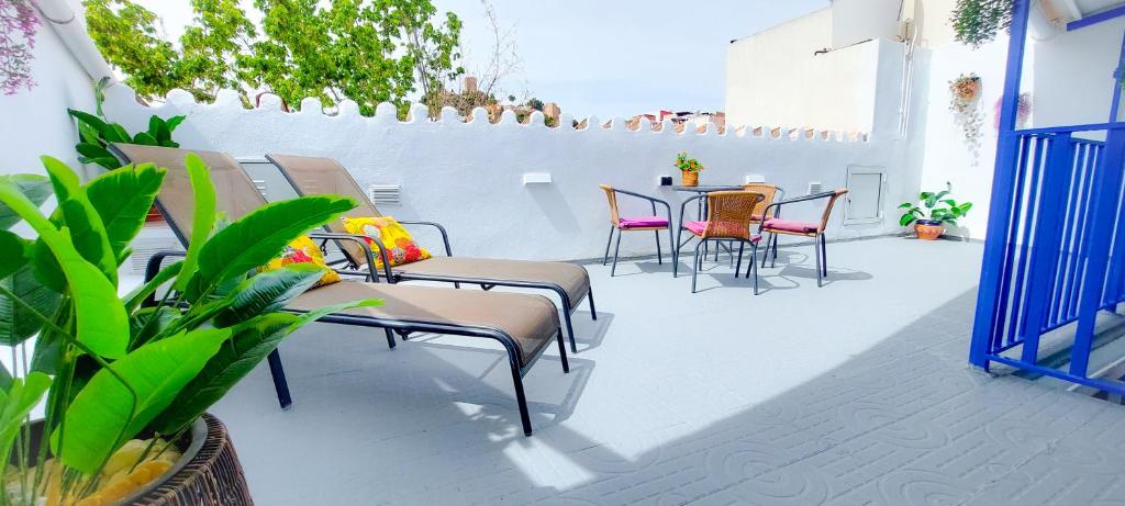 a patio with chairs and tables and a table and chairs at VelenaRubia in Vélez-Málaga