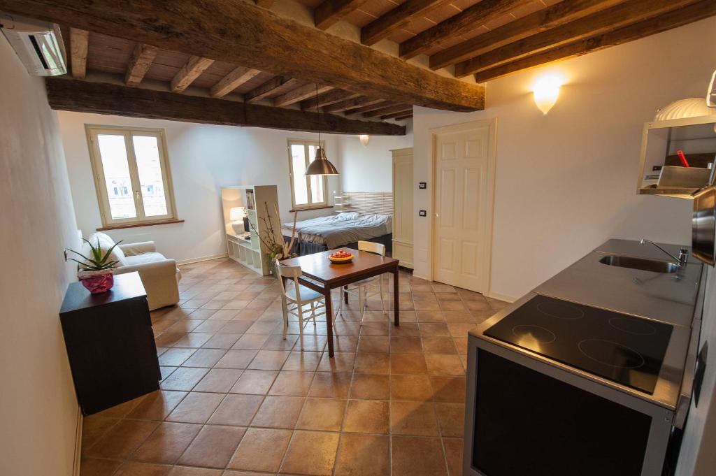 a kitchen and a living room with a table at B&B Le Grazie in Parma