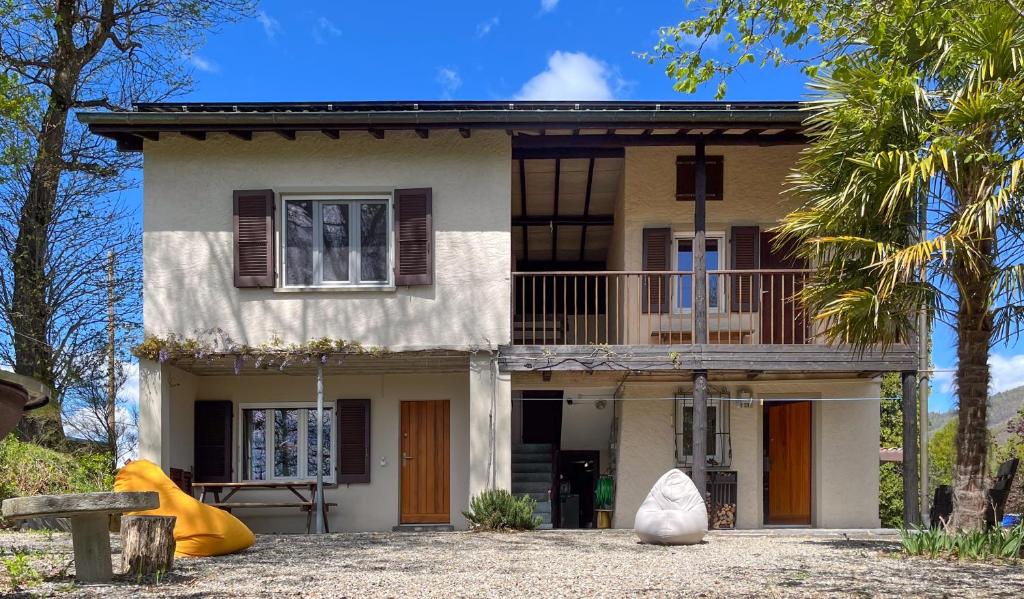 a house with a balcony on top of it at Casa Roccolo in Astano