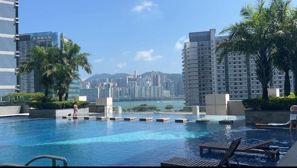 a large swimming pool in a city with buildings at Harbour Nest in Hong Kong