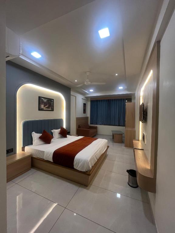 a bedroom with a large bed in a room at Hotel Sun Icon in Vadodara