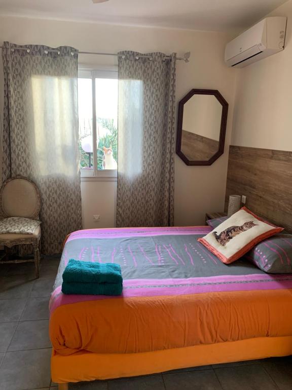 a bedroom with a large bed with a mirror at La Escala in La Celle-sous-Gouzon