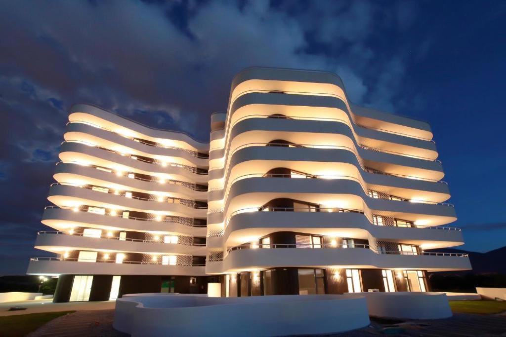 a white apartment building with its lights on at Sarajevo Waves Aparthotel in Sarajevo