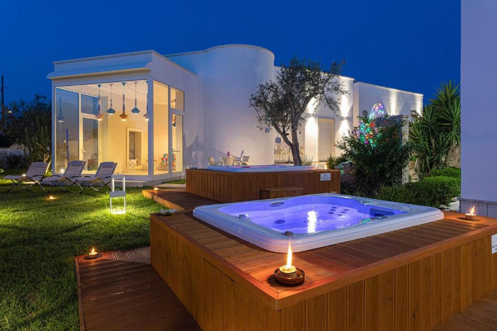 a jacuzzi tub in the backyard of a house at Le Gemelle Boutique Hotel in Torre Suda