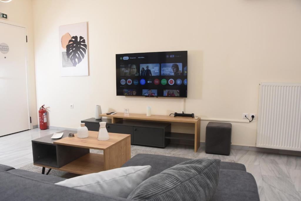 a living room with a couch and a tv on the wall at Sparta Central Apartment with Free Parking in Sparta