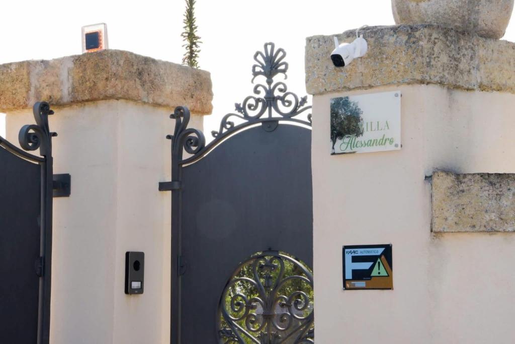 a gate on the side of a building at Villa Alessandro in Poggiardo