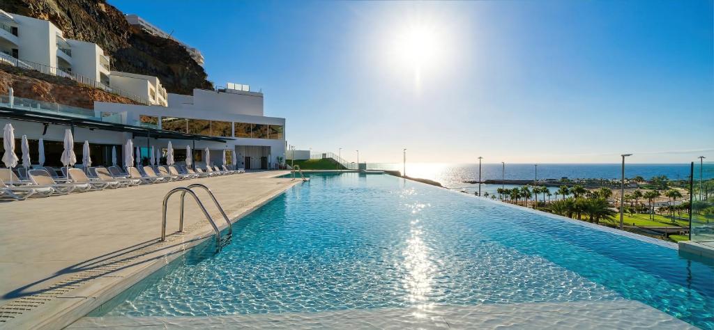 a swimming pool with a view of the ocean at Amadores View - Adults only in Mogán