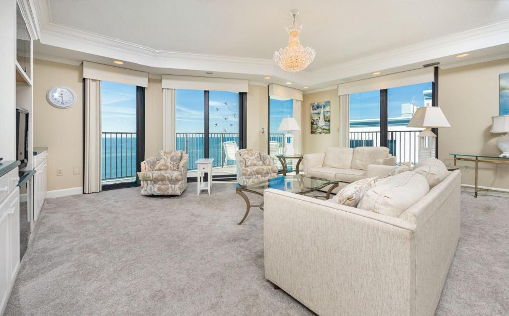 a living room with a couch and a table and chairs at Phoenix East 1401 in Orange Beach