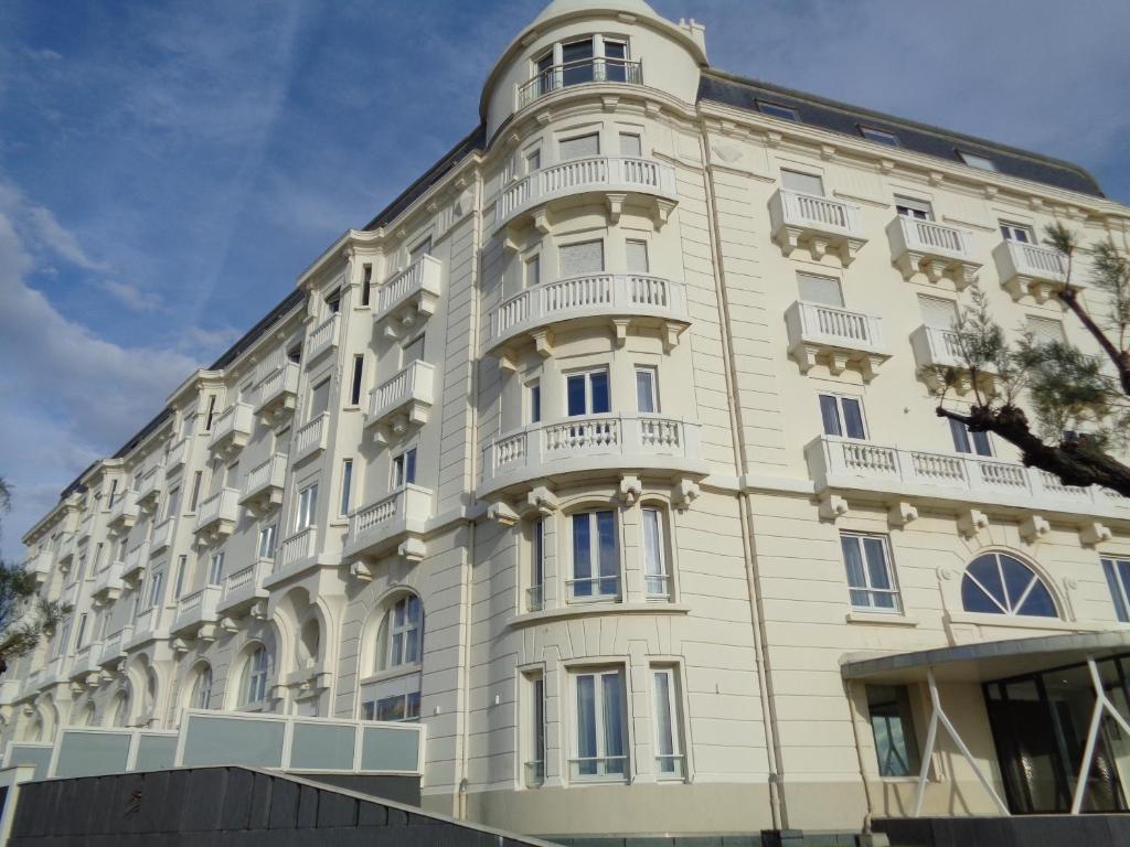 a white building with balconies on the side of it at Studio Privé Résidence Regina in Biarritz