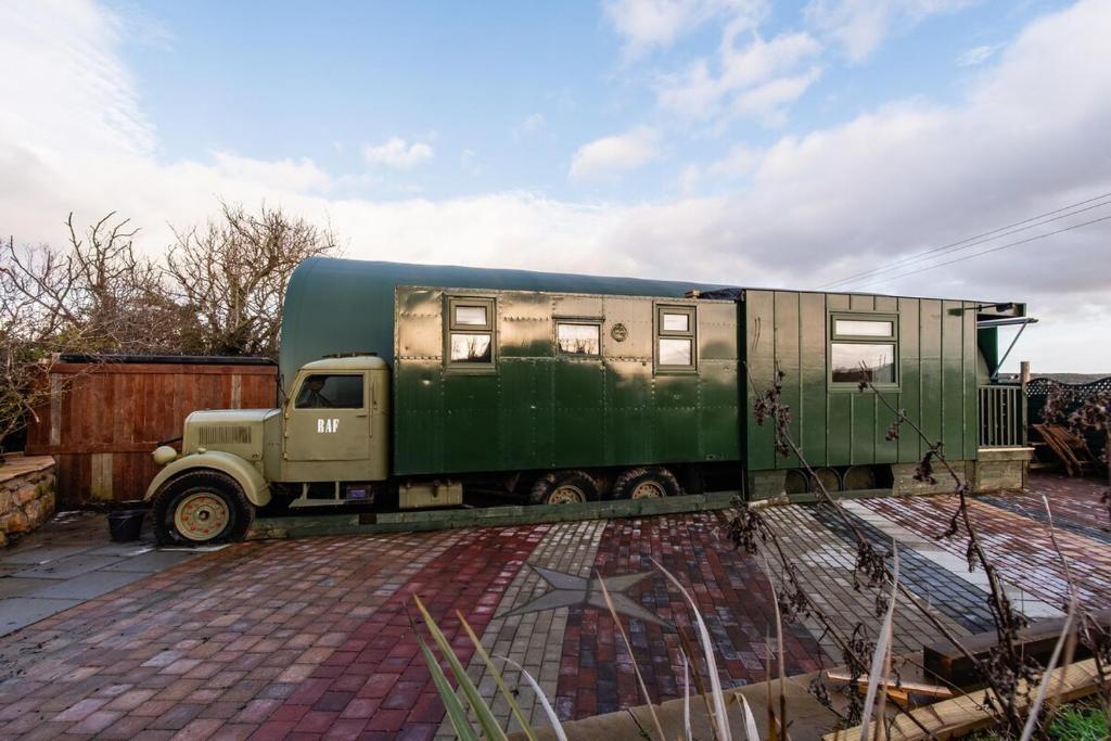 a green truck with a horse trailer on it at The Truck in Longframlington