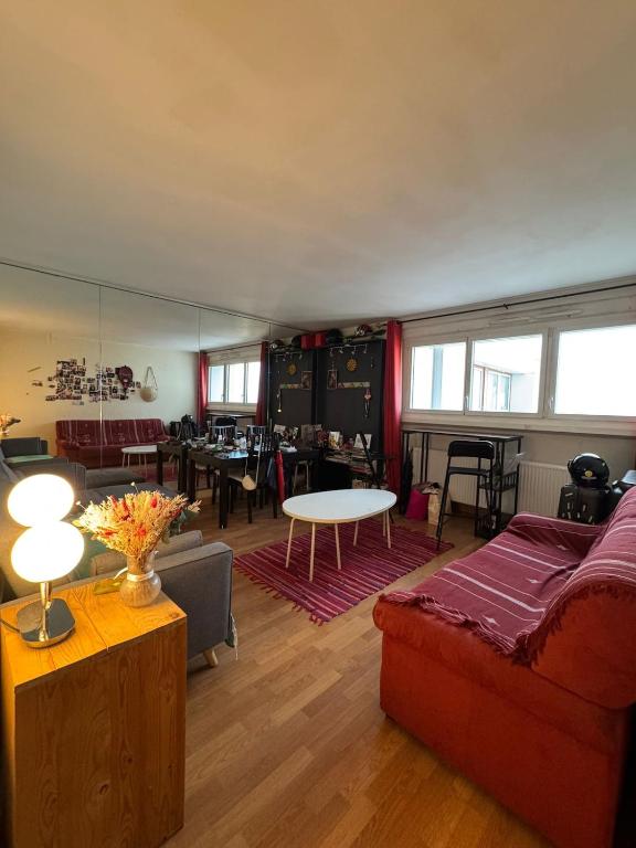 a living room with a couch and a table at Eiffel Tower view & Swimming Pool, Cosy appartment - Center in Paris