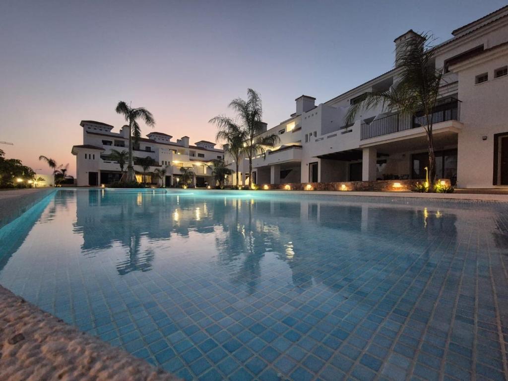 a large swimming pool in front of a building at Serenity Garden & Spa in Los Alcázares