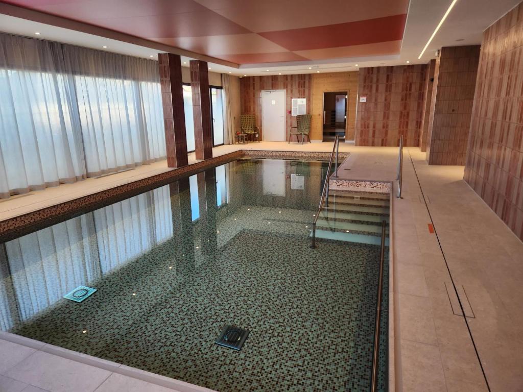 a swimming pool in a hotel room at DOMITYS - Les Arilles in Ifs