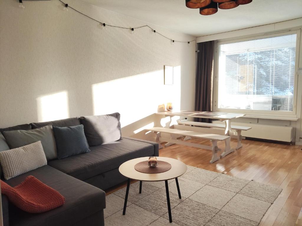 a living room with a couch and a table at Kaksio lähellä keskustaa in Iisalmi
