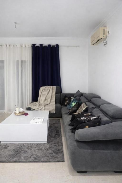 a living room with a couch and a coffee table at Condominio hortencia in Viana