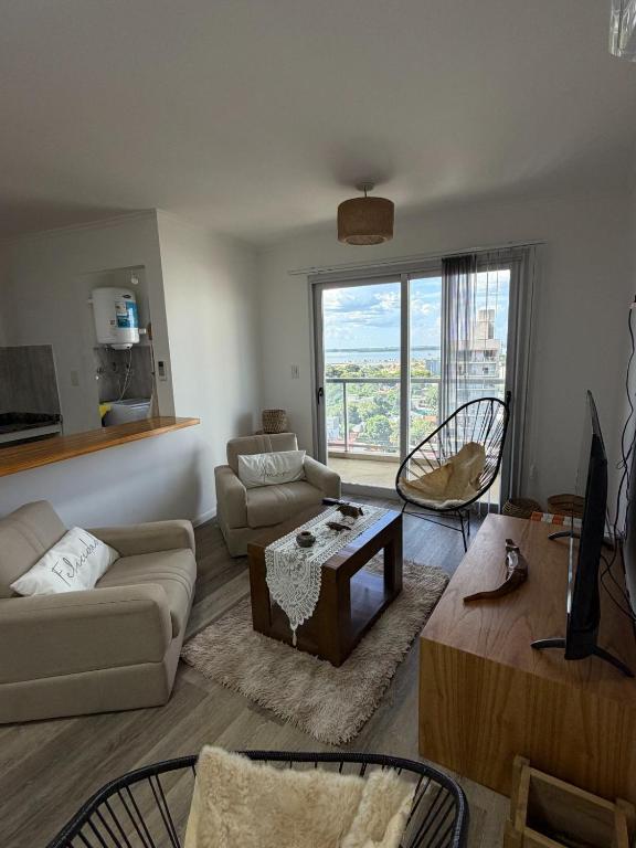 a living room with a couch and a table at Torre Aymara 8C in Posadas