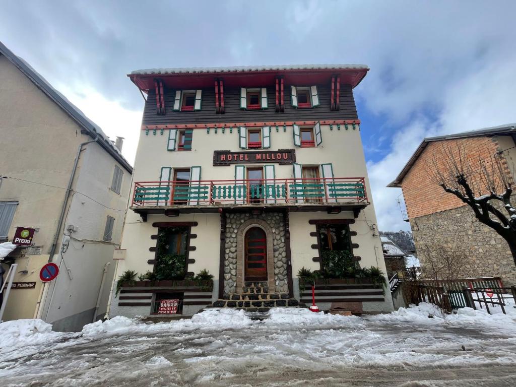 a building with a sign on it in the snow at Chalet Millou Beuil in Beuil