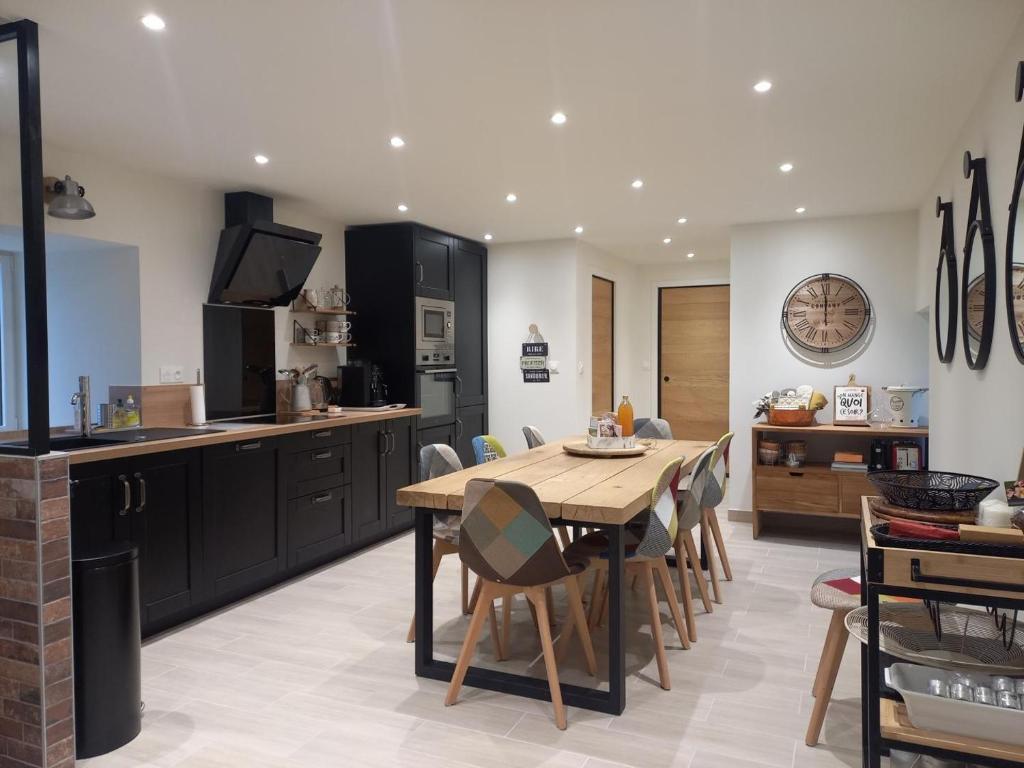 a kitchen and dining room with a table and chairs at Domaine la jarrie in La Bussière