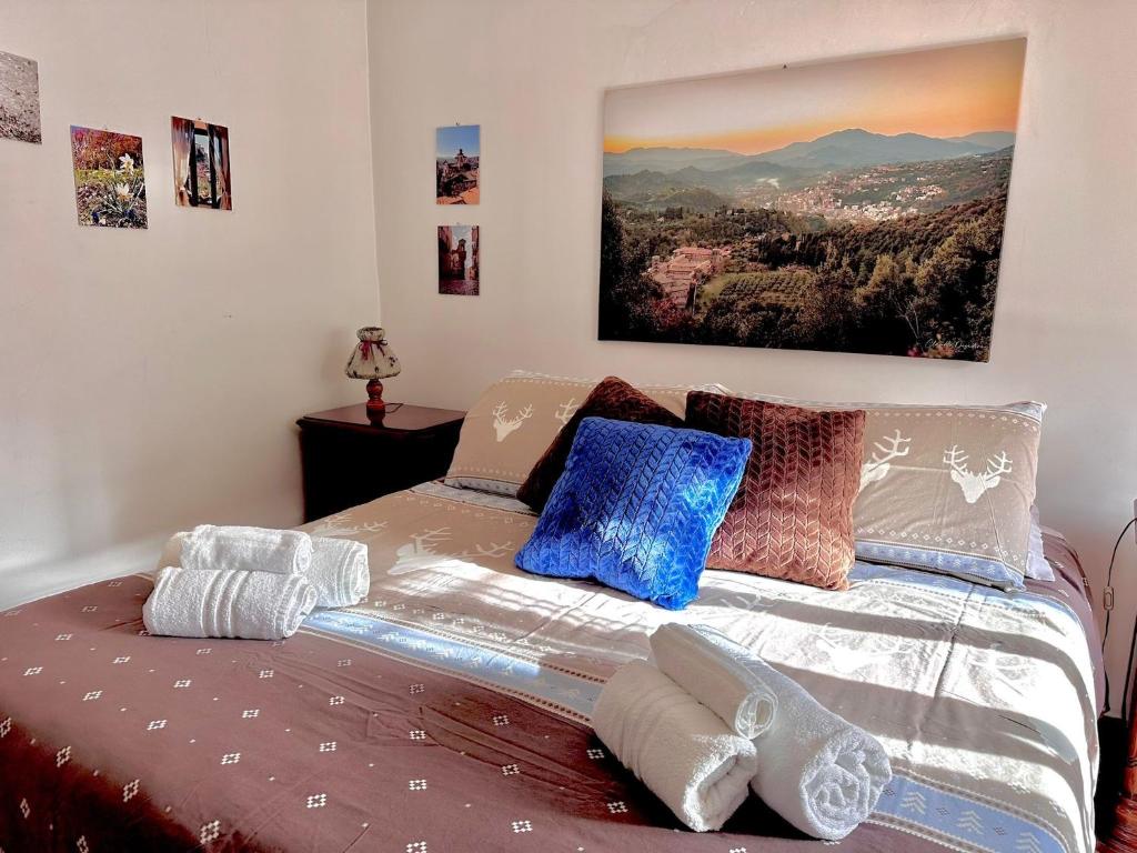 a bedroom with a bed with pillows on it at LA GROTTA Guest House Subiaco in Subiaco