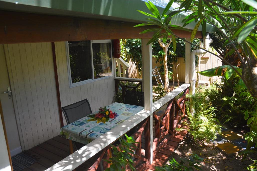 a porch of a house with a bench on it at Fare Maheata in Pihaena