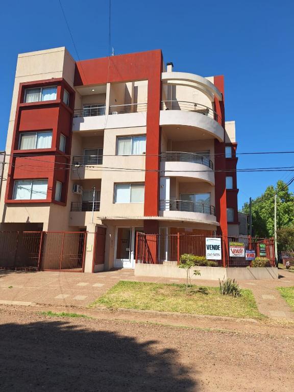 a tall building with a red and white at Artigas 505 dpto 2 in Colón