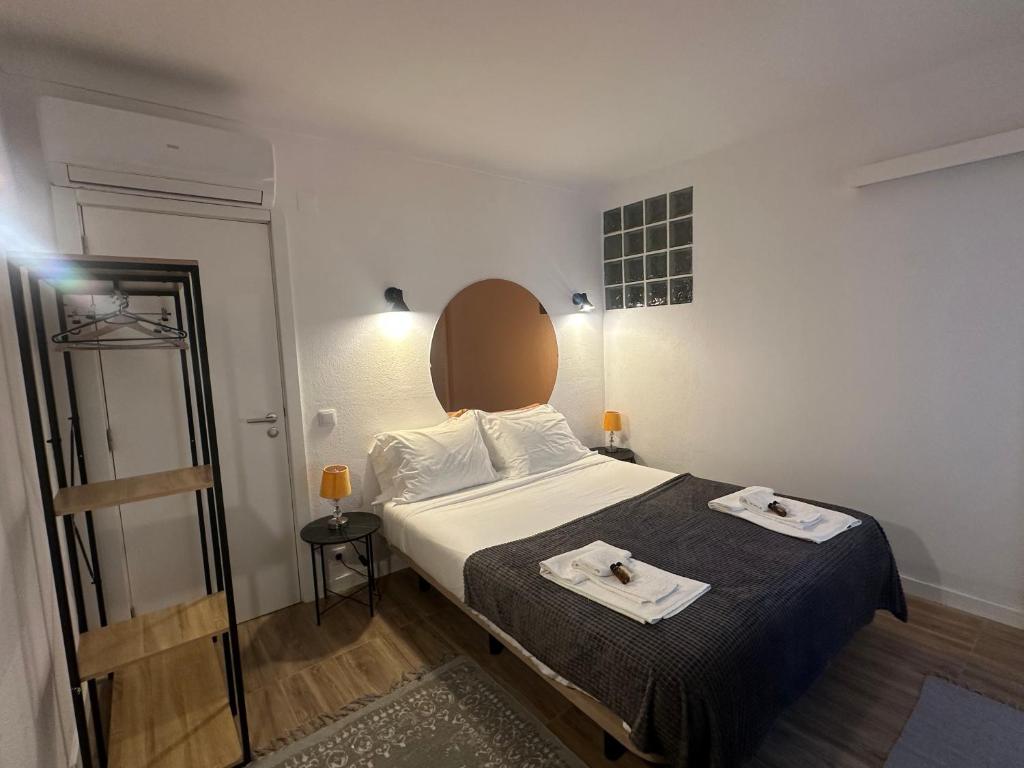 a bedroom with a bed with two towels on it at Penedo Escape Retreat in Colares