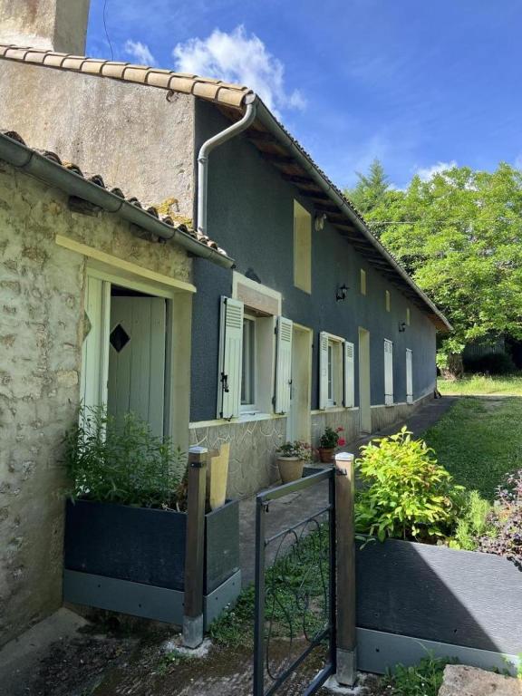 a house with a fence in front of it at La maison de preuillé in Payré