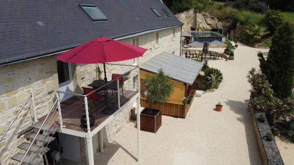an overhead view of a building with a red umbrella at Gite 24 in Beaumont