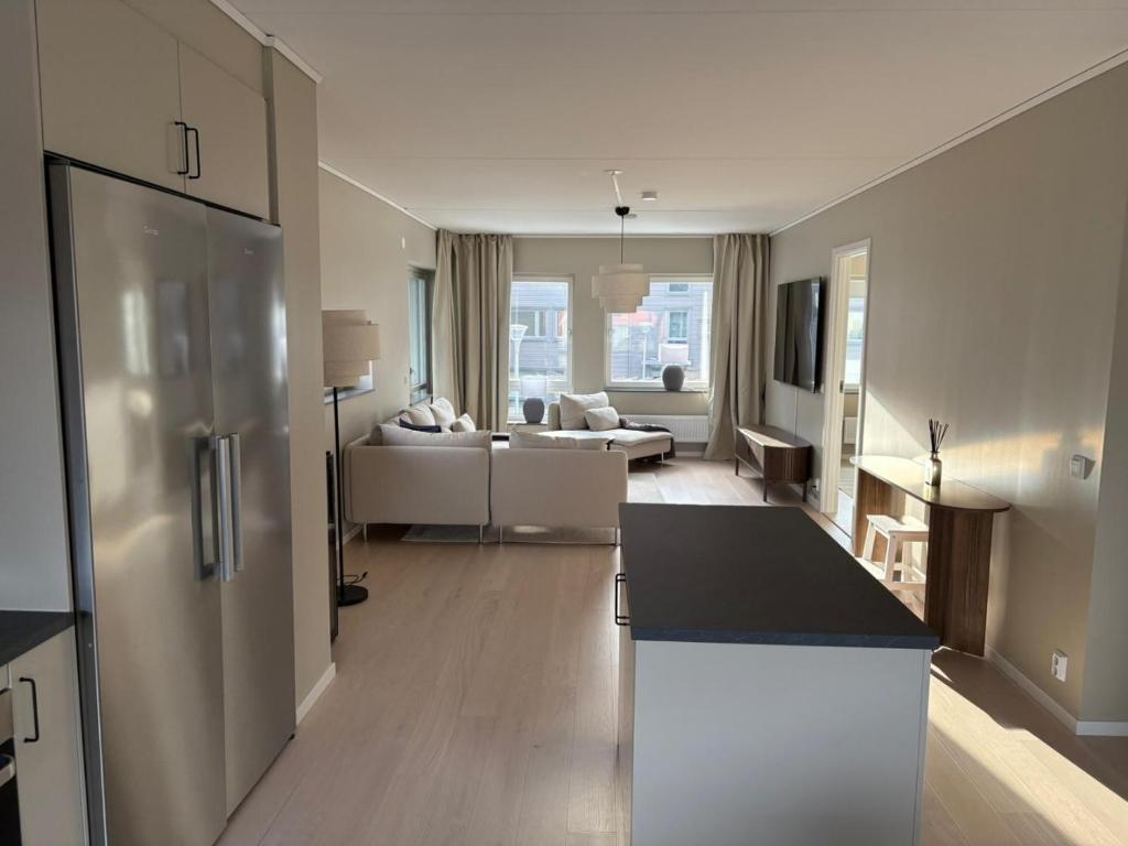 a living room with a kitchen and a living room with a couch at Bexam Apartment in Växjö