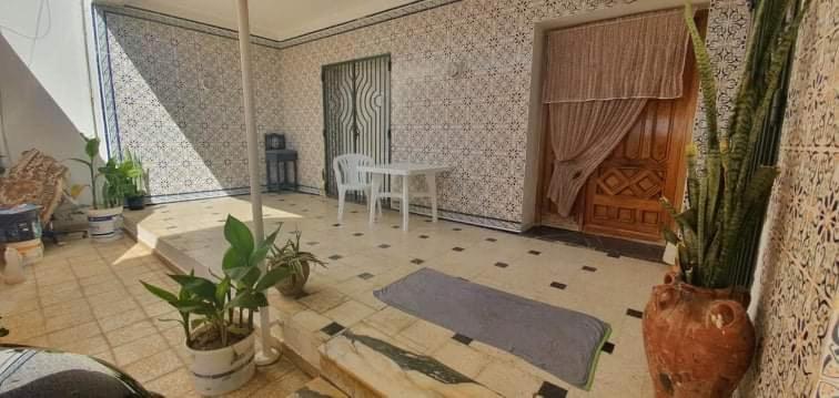 a living room with a table and some plants at Salmane Villa in Nabeul