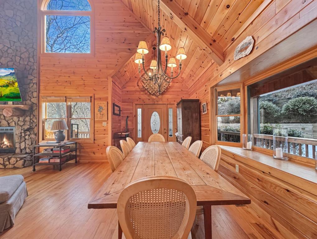 a dining room with a wooden table and chairs at Johnny's Lakeside Hideaway in Morganton