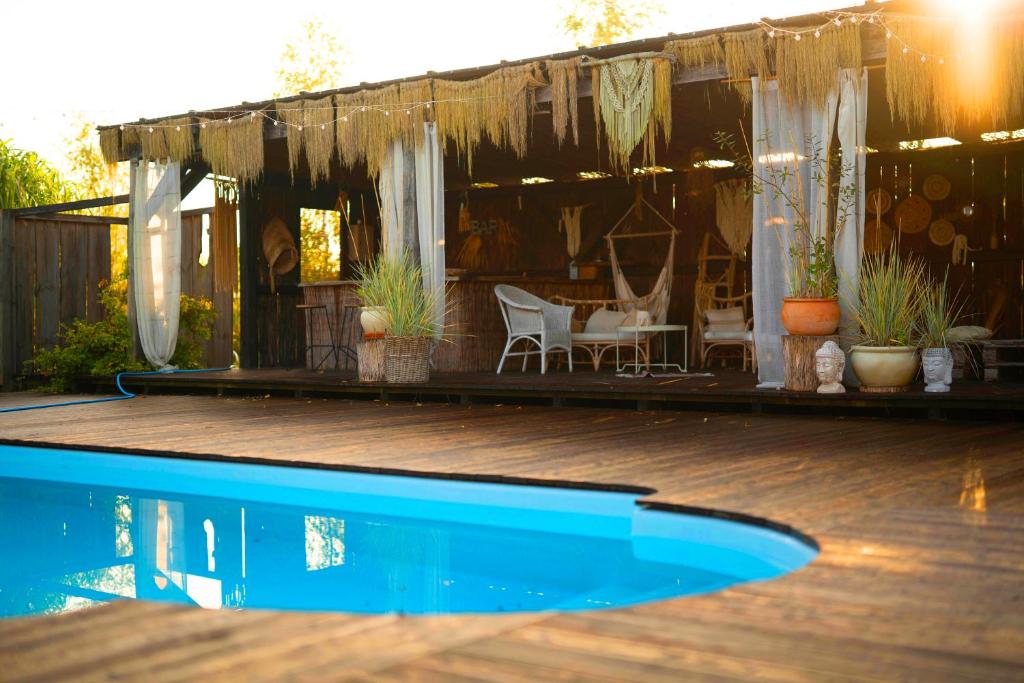 a house with a swimming pool and a patio at Pod Mazurskim Niebem boho in Piecki