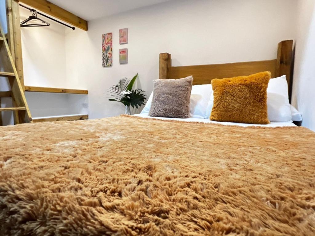 a bedroom with a large bed with pillows at Casa Santa Rosa Garden in Santa Rosa de Cabal