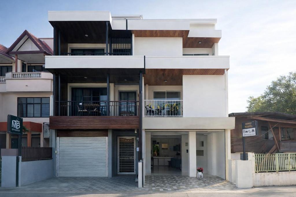 a building with a dog standing in front of it at Family Hostel in Chiang Rai