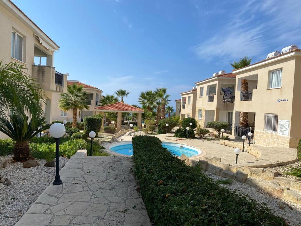 a villa with a swimming pool in front of a building at Tala Rivera Paradise in Tala