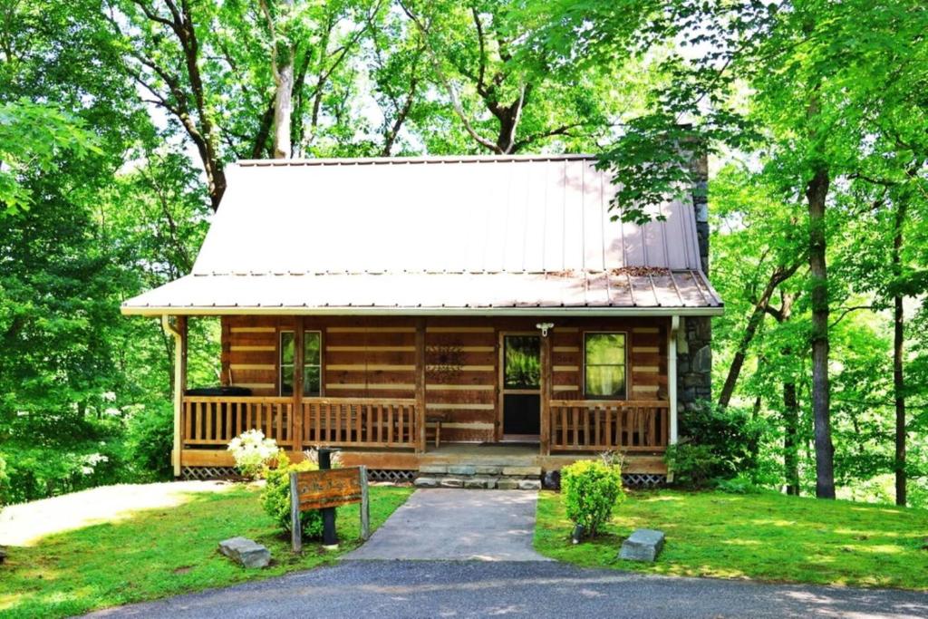 a small log cabin with a white roof at The Ridge in Cherokee