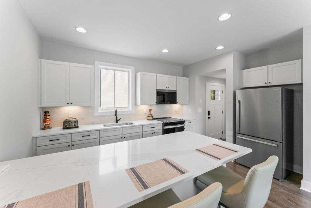 a kitchen with a white table and a refrigerator at McCormick Retreat in Knoxville