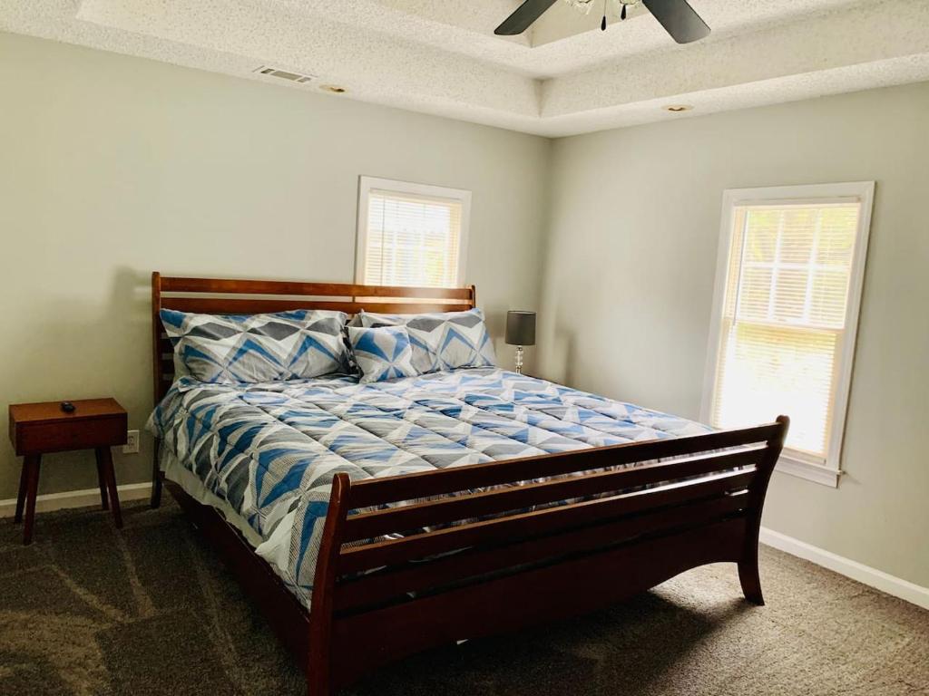 a bedroom with a bed with a blue comforter at Hartsfield Jackson Escape in College Park