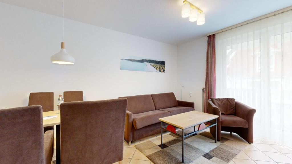 a living room with a couch and a table at Appartementhaus Binzer Sterne 09 in Binz