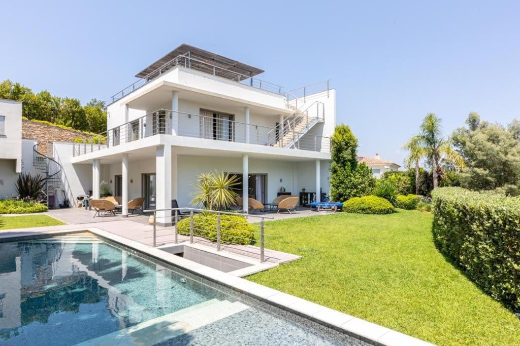 a house with a swimming pool in front of it at FRGK Luxury Two-Storey Villa with Pool & Rooftop Peaceful Setting Lord Brougham in Cannes