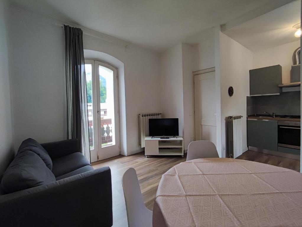 a living room with a couch and a table at La Strada di Tiziano in Pieve di Cadore