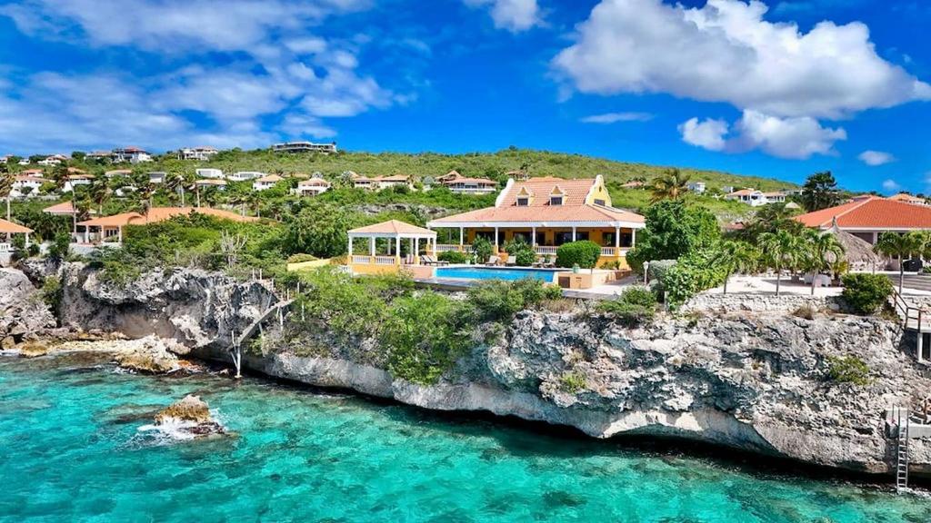 an aerial view of a home on a rocky cliff at Villa Landhuis 6 - Coral Estate in Willibrordus