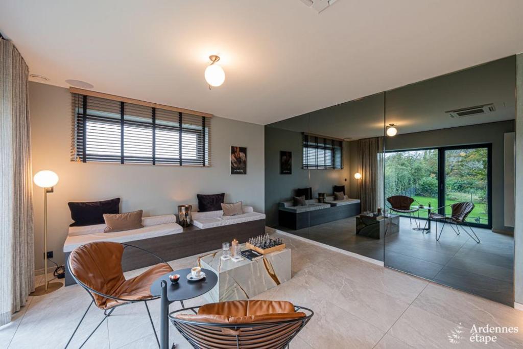 a large room with a bed and a living room at Loft La Suite et sa Suite in Thimister